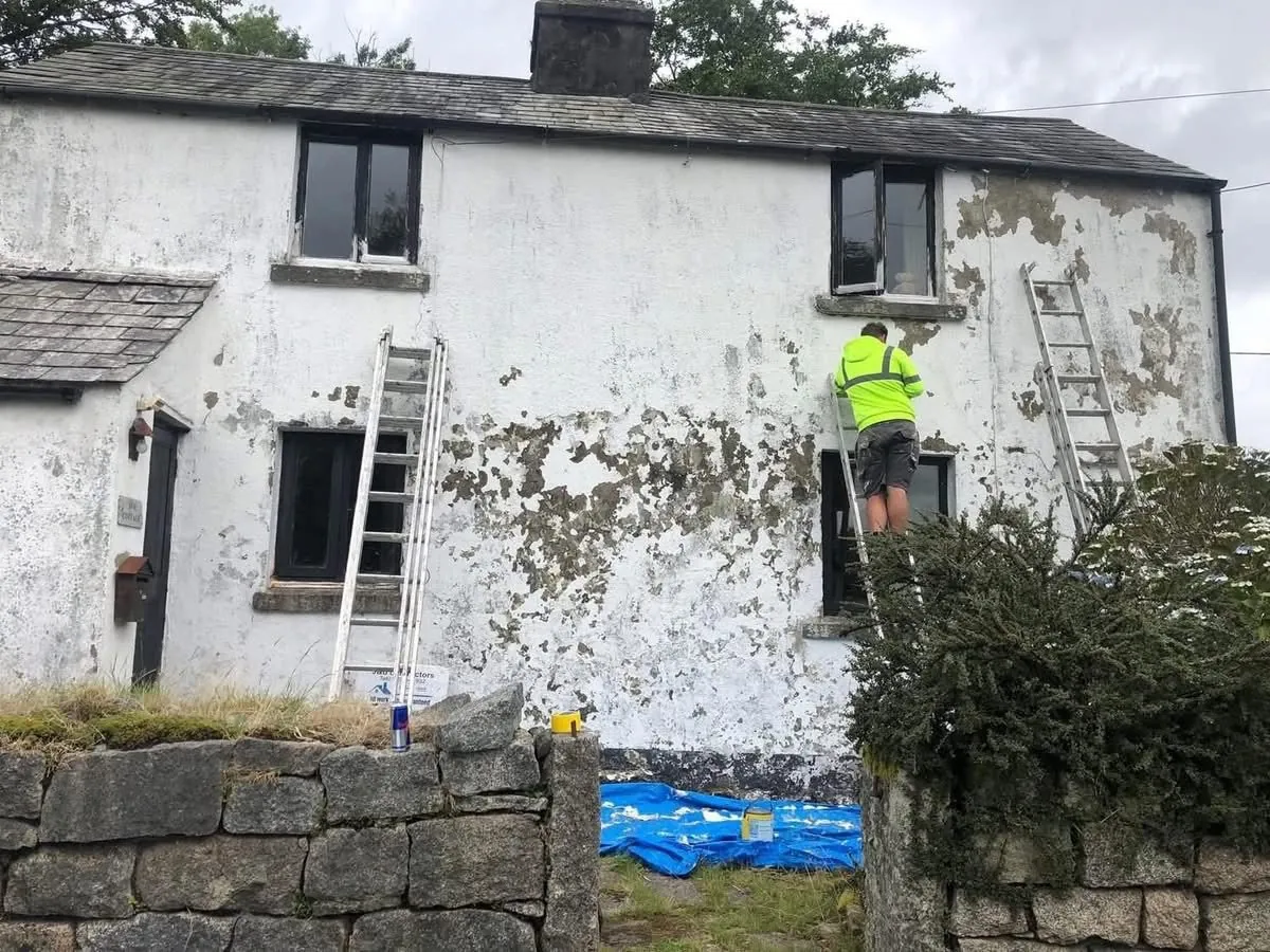 Cottage with blown, flaking render before repair in Camelford